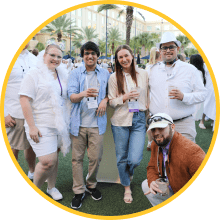 Several MOMENTUM attendees posing for the camera while enjoying the outdoor Welcome Reception